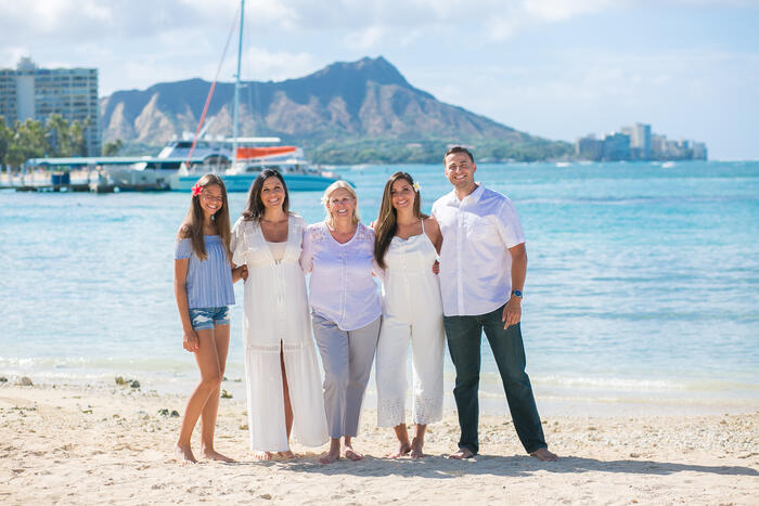 Family of five on the beach with Diamond Head in the background