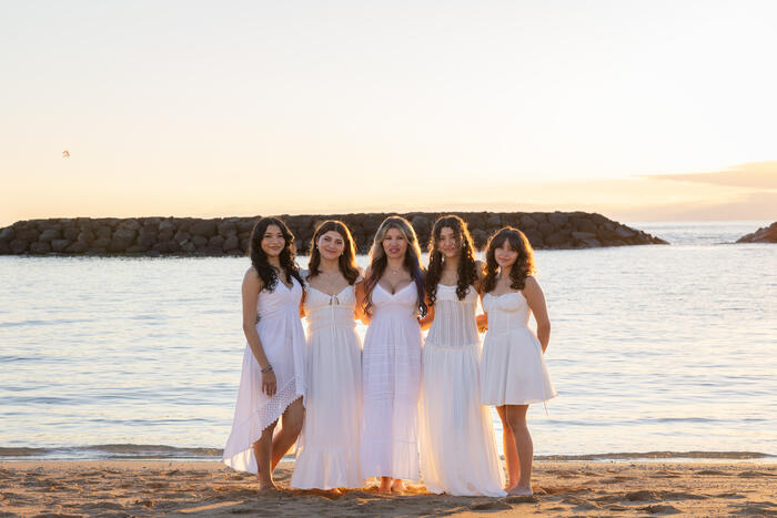 Mother and daughters on the beach at sunset